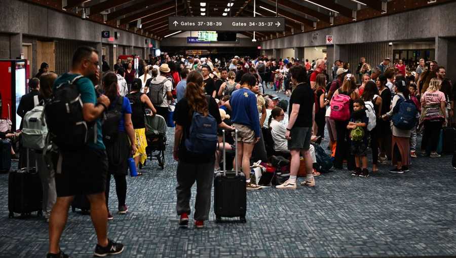 US-FIRES-HAWAII Passengers try to rest and sleep after canceled and delayed flights while others wait to board flights off the island as thousands of passengers were stranded at the Kahului Airport (OGG) in the aftermath of wildfires in western Maui in Kahului, Hawaii on August 9, 2023. The death toll from a wildfire that turned a historic Hawaiian town to ashes has risen to 36 people, officials said on August 9. (Photo by Patrick T. Fallon / AFP) (Photo by PATRICK T. FALLON/AFP via Getty Images)