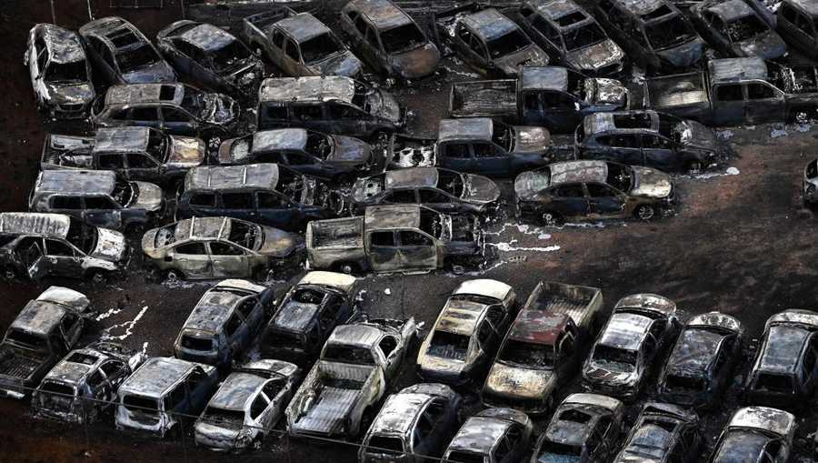 US-FIRE-HAWAII An aerial image taken on August 10, 2023 shows destroyed cars in Lahaina in the aftermath of wildfires in western Maui, Hawaii. At least 36 people have died after a fast-moving wildfire turned Lahaina to ashes, officials said August 9, 2023 as visitors asked to leave the island of Maui found themselves stranded at the airport. The fires began burning early August 8, scorching thousands of acres and putting homes, businesses and 35,000 lives at risk on Maui, the Hawaii Emergency Management Agency said in a statement. (Photo by Patrick T. Fallon / AFP) (Photo by PATRICK T. FALLON/AFP via Getty Images)