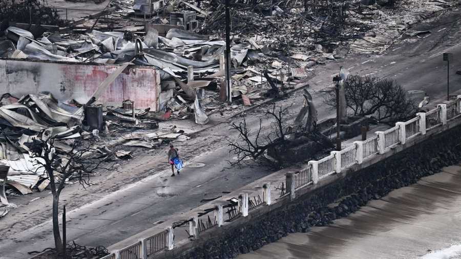 US-FIRE-HAWAII An aerial image taken on August 10, 2023 shows a person walking down Front Street past destroyed buildings burned to the ground in Lahaina in the aftermath of wildfires in western Maui, Hawaii. At least 36 people have died after a fast-moving wildfire turned Lahaina to ashes, officials said August 9, 2023 as visitors asked to leave the island of Maui found themselves stranded at the airport. The fires began burning early August 8, scorching thousands of acres and putting homes, businesses and 35,000 lives at risk on Maui, the Hawaii Emergency Management Agency said in a statement. (Photo by Patrick T. Fallon / AFP) (Photo by PATRICK T. FALLON/AFP via Getty Images)