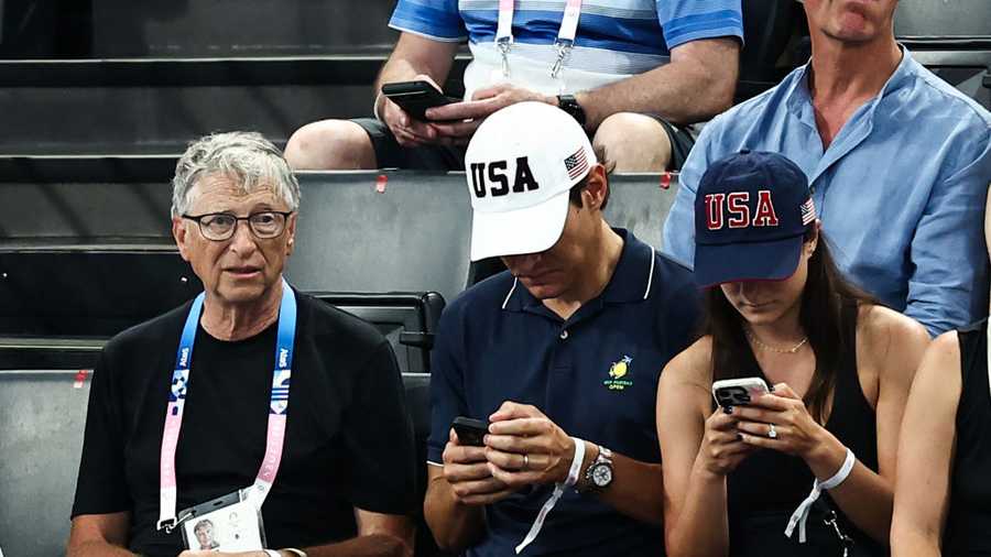 GYMNASTICS-ARTISTIC-OLY-PARIS-2024-VIP US businessman Bill Gates (L) waits for the start of the artistic gymnastics women's team final during the Paris 2024 Olympic Games at the Bercy Arena in Paris, on July 30, 2024. (Photo by Anne-Christine POUJOULAT / AFP) (Photo by ANNE-CHRISTINE POUJOULAT/AFP via Getty Images)