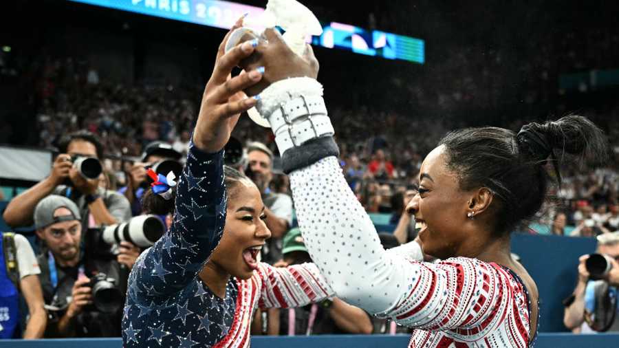 GYMNASTICS-ARTISTIC-OLY-PARIS-2024 US' Simone Biles (R) celebrates with US' Jordan Chiles s seen during the artistic gymnastics women's team final during the Paris 2024 Olympic Games at the Bercy Arena in Paris, on July 30, 2024. (Photo by Lionel BONAVENTURE / AFP) (Photo by LIONEL BONAVENTURE/AFP via Getty Images)