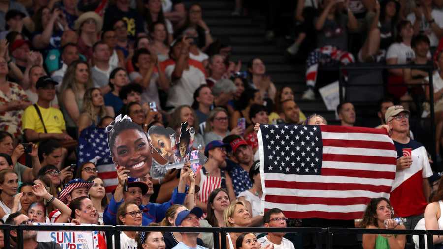 Artistic Gymnastics - Olympic Games Paris 2024: Day 4 PARIS, FRANCE - JULY 30: Fans of Team United States cheer and hold signs during the Artistic Gymnastics Women's Team Final on day four of the Olympic Games Paris 2024 at Bercy Arena on July 30, 2024 in Paris, France. (Photo by Jamie Squire/Getty Images)